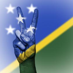Solomons flag overlay colouring a hand doing the peace sign