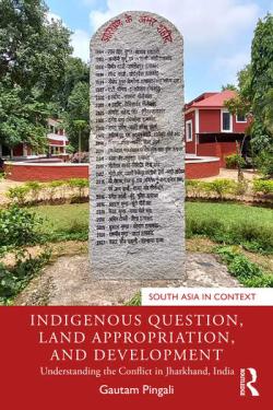 Book cover for Indigenous Question, Land Appropriation and Development, showing a large marker stone with Indian writing within a built environment's garden setting 