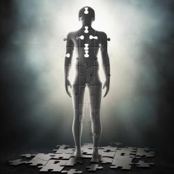 An android-like figure stands silhouetted by light, limbs patterned in the outline of jigsaw pieces