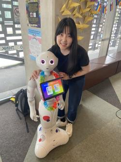 Mina Jang with the Pepper Robot programmed for Pride Week