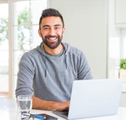 Man with beard in front of laptop